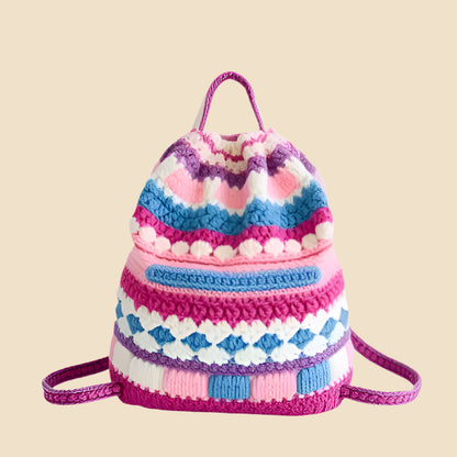 Colorful knitted drawstring bag on a pink background