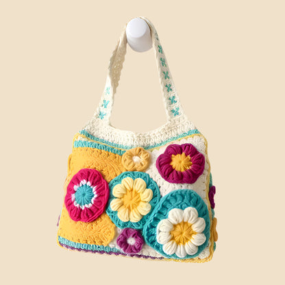 Colorful crocheted bag with floral patterns on a pink background